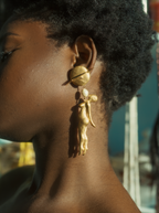 Woman looking to "SATURN" Earrings