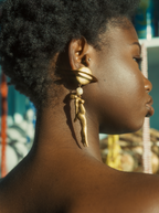 Woman looking to "SATURN" Earrings